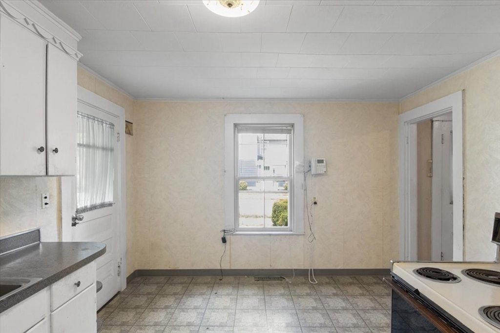 50 Clark Street Dedham, MA 02026 - Photo 6 of 38 a kitchen with white cabinets and window