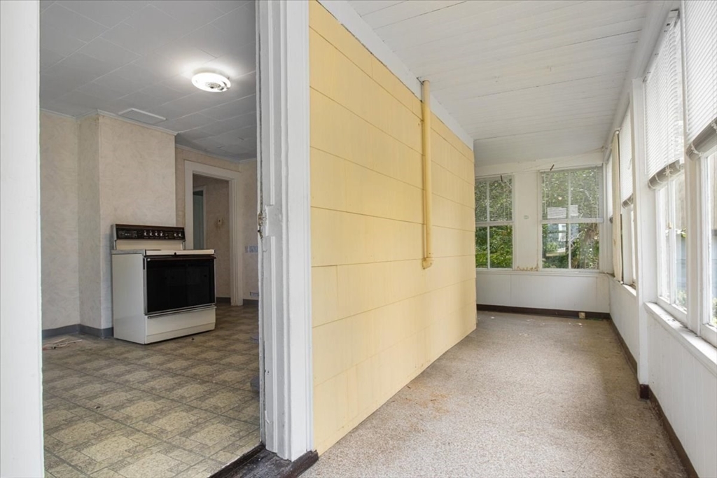 50 Clark Street Dedham, MA 02026 - Photo 7 of 38 a view of a hallway with an empty room and fire place