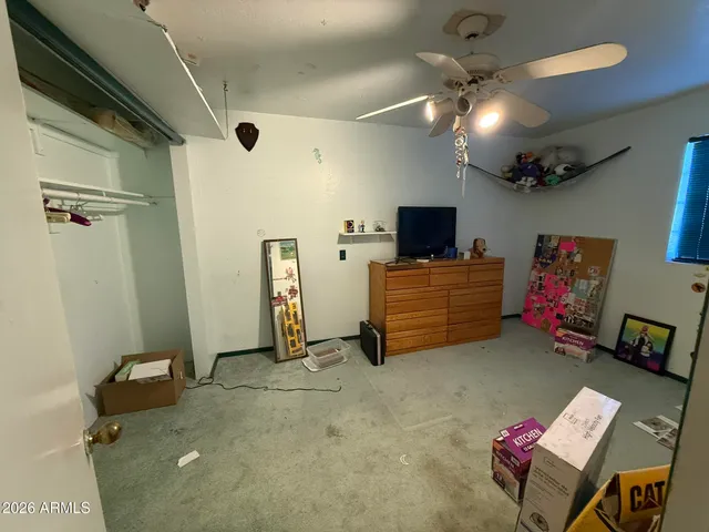 a workspace with furniture and a fan