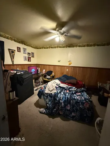 a bed sitting in a bedroom next to a lamp