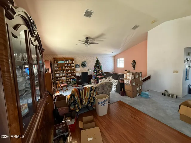a view of a dining room with furniture and a chandelier