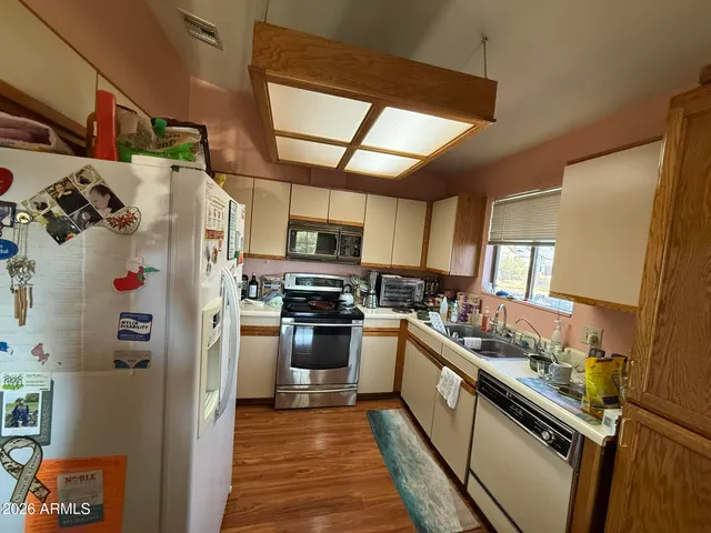 a kitchen with stainless steel appliances granite countertop a refrigerator and a stove