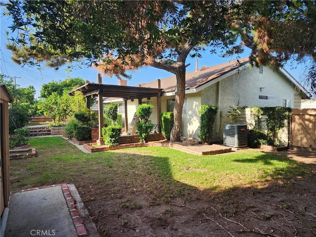 a view of a house with backyard porch and sitting area