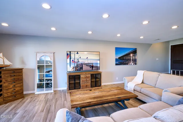 a kitchen with stainless steel appliances granite countertop a sink and a refrigerator