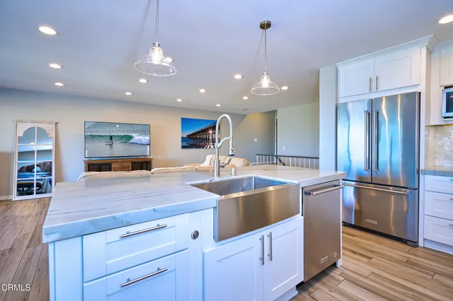 a kitchen with granite countertop a stove and a microwave