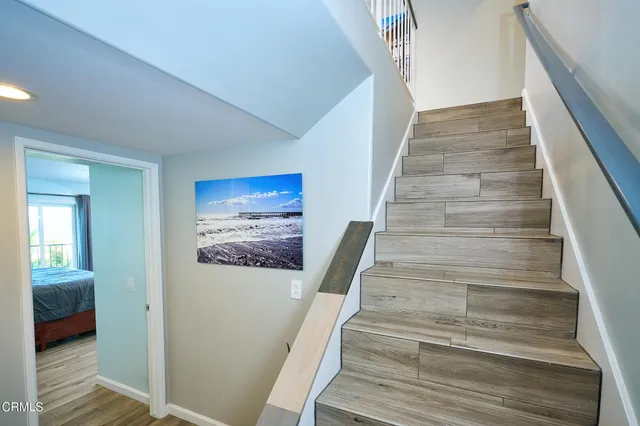 a bathroom with a granite countertop sink a mirror and shower