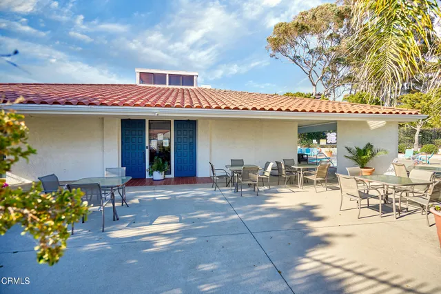 a view of a patio with a table and chairs