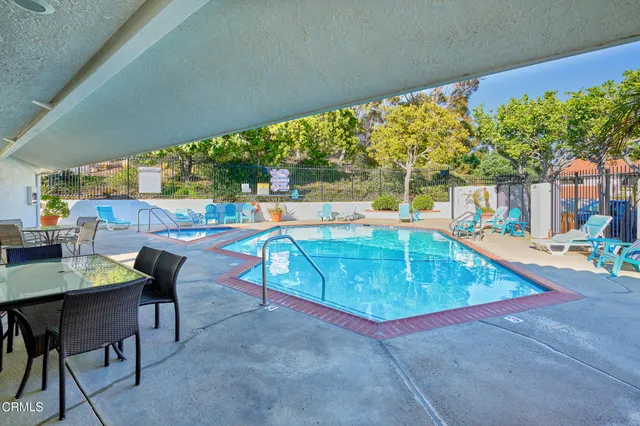 a view of swimming pool with outdoor seating and lake view
