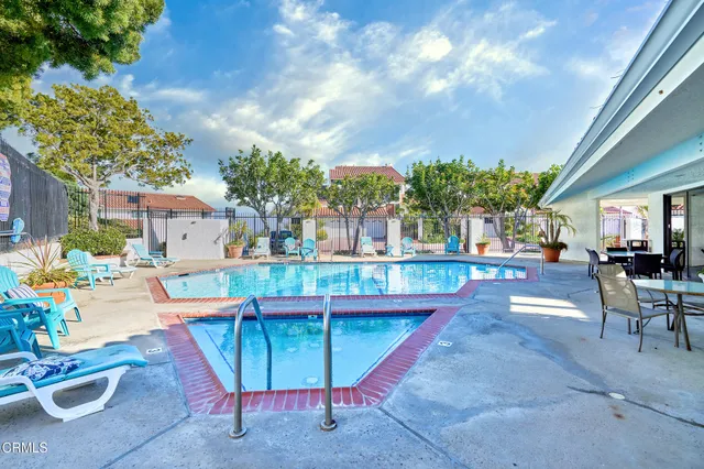 a view of a house with backyard and sitting area