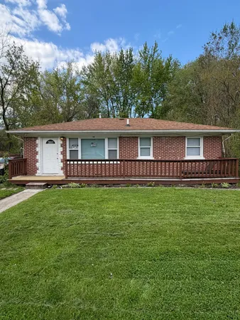a kitchen with stainless steel appliances granite countertop wooden cabinets a stove a sink and a window