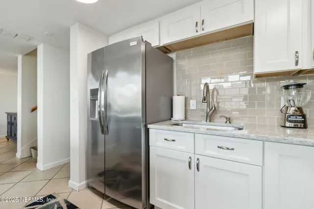 a kitchen with appliances a sink and cabinets