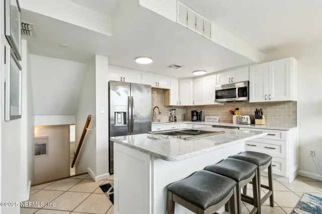 a dining room with furniture and a mirror
