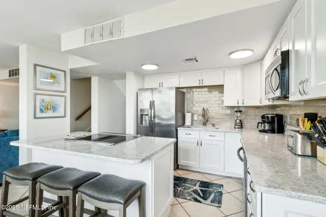 a dining room with furniture a mirror and wooden floor