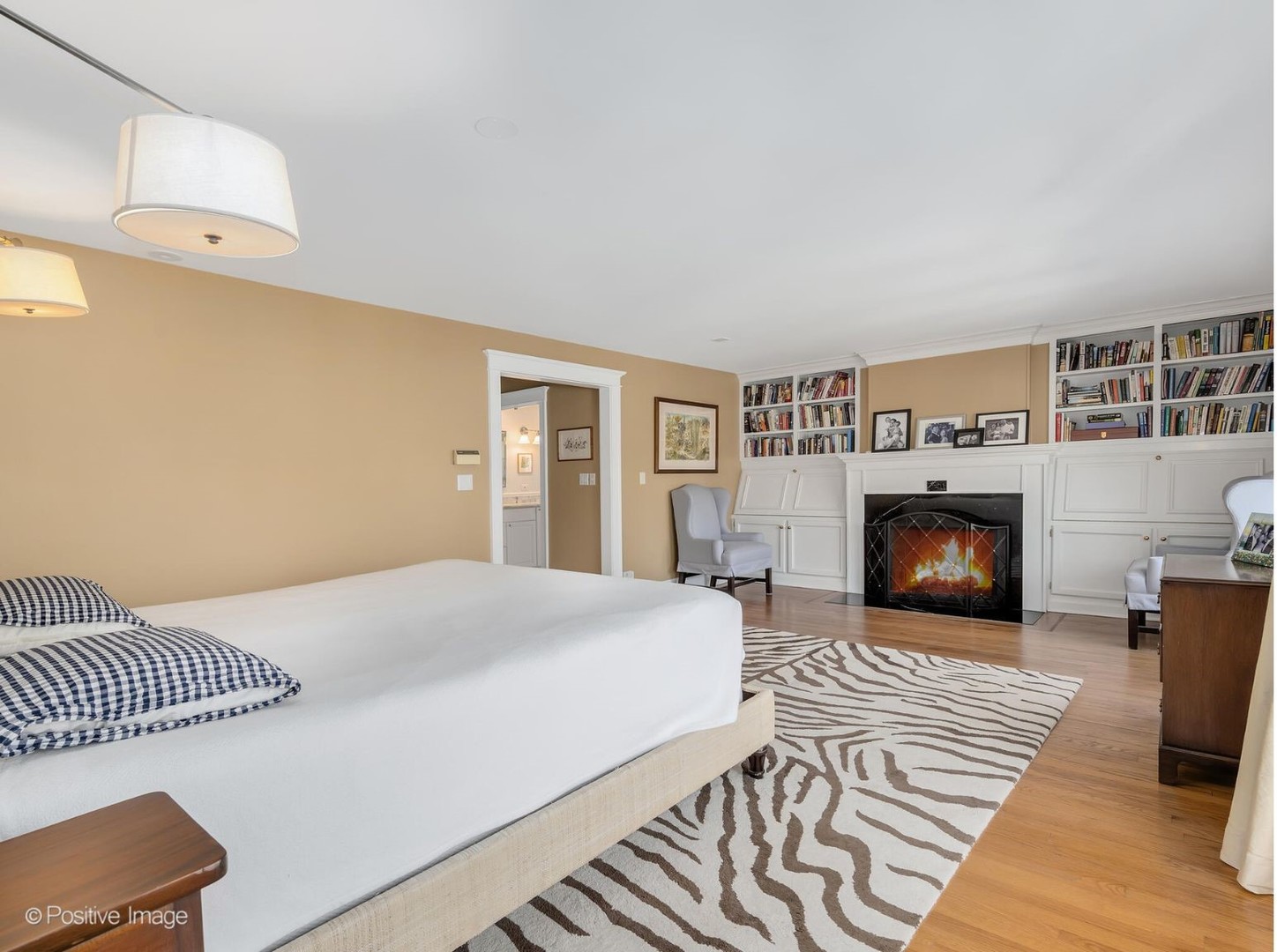 607 Willow Road Winnetka, IL 60093 - Photo 19 of 51 a bedroom with a large bed and a fireplace