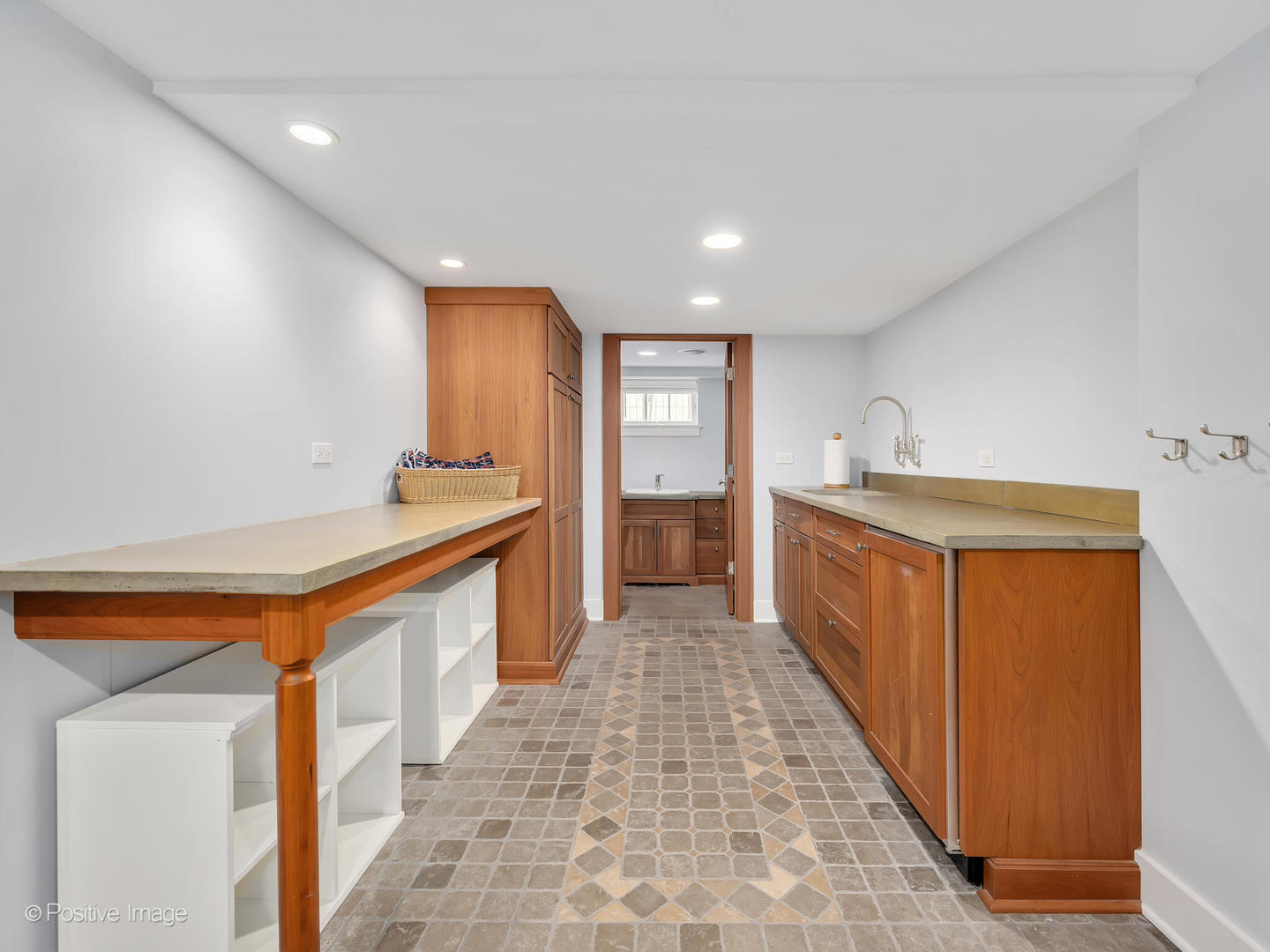 607 Willow Road Winnetka, IL 60093 - Photo 40 of 51 a kitchen with stainless steel appliances granite countertop a sink and a refrigerator