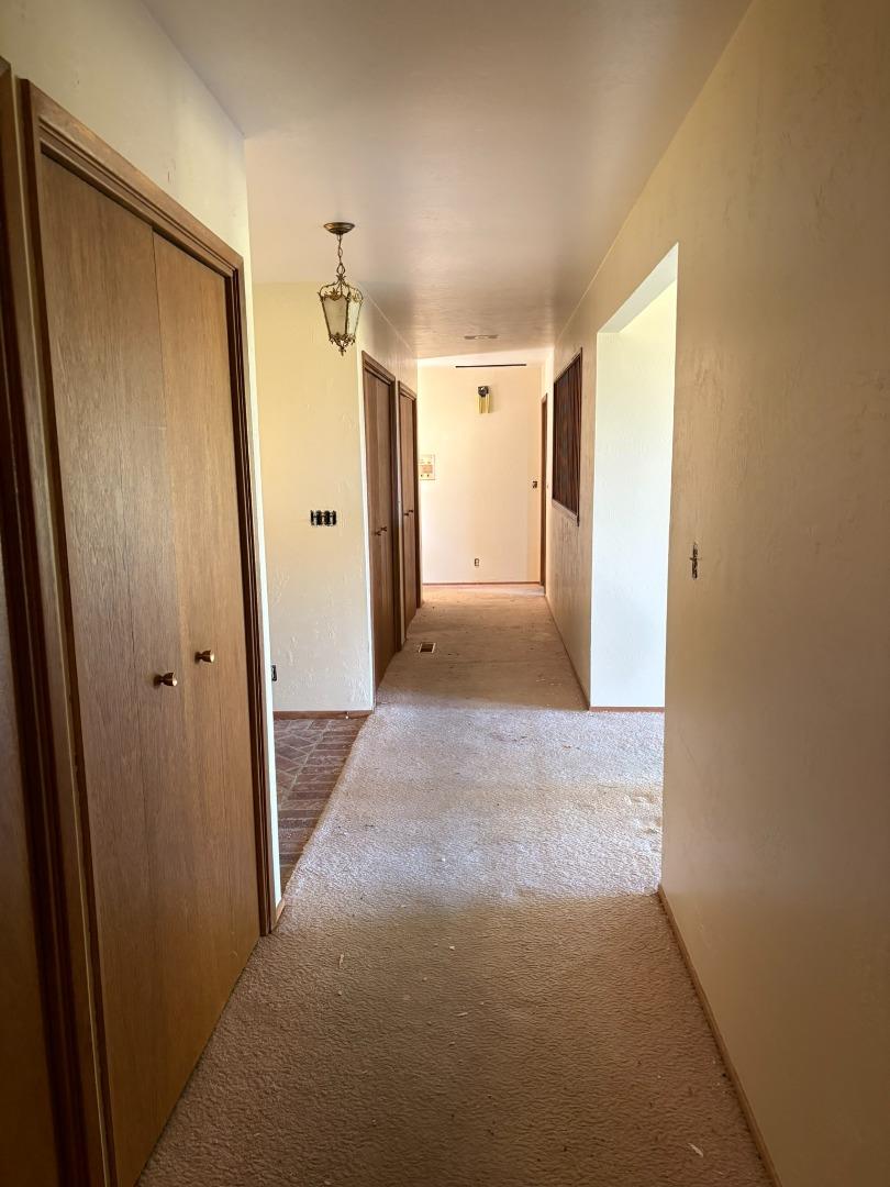 12130 Foothill Lane Los Altos Hills, CA 94022 - Photo 11 of 13 a view of a hallway with wooden shelves