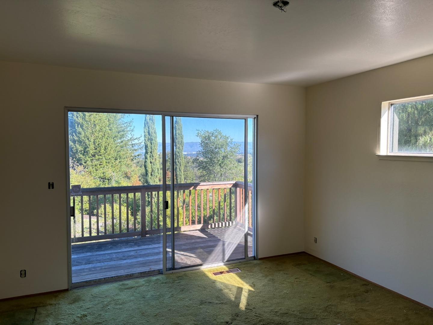 12130 Foothill Lane Los Altos Hills, CA 94022 - Photo 4 of 13 a view of an empty room with wooden floor and a window