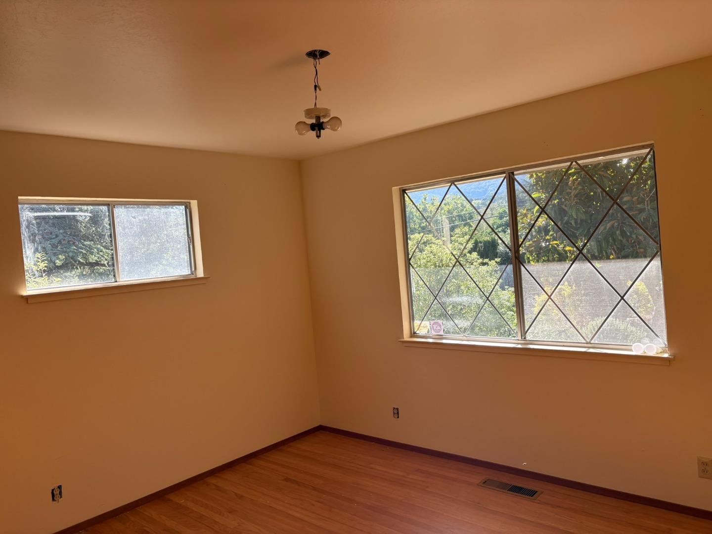 12130 Foothill Lane Los Altos Hills, CA 94022 - Photo 5 of 13 a view of an empty room with wooden floor and a window