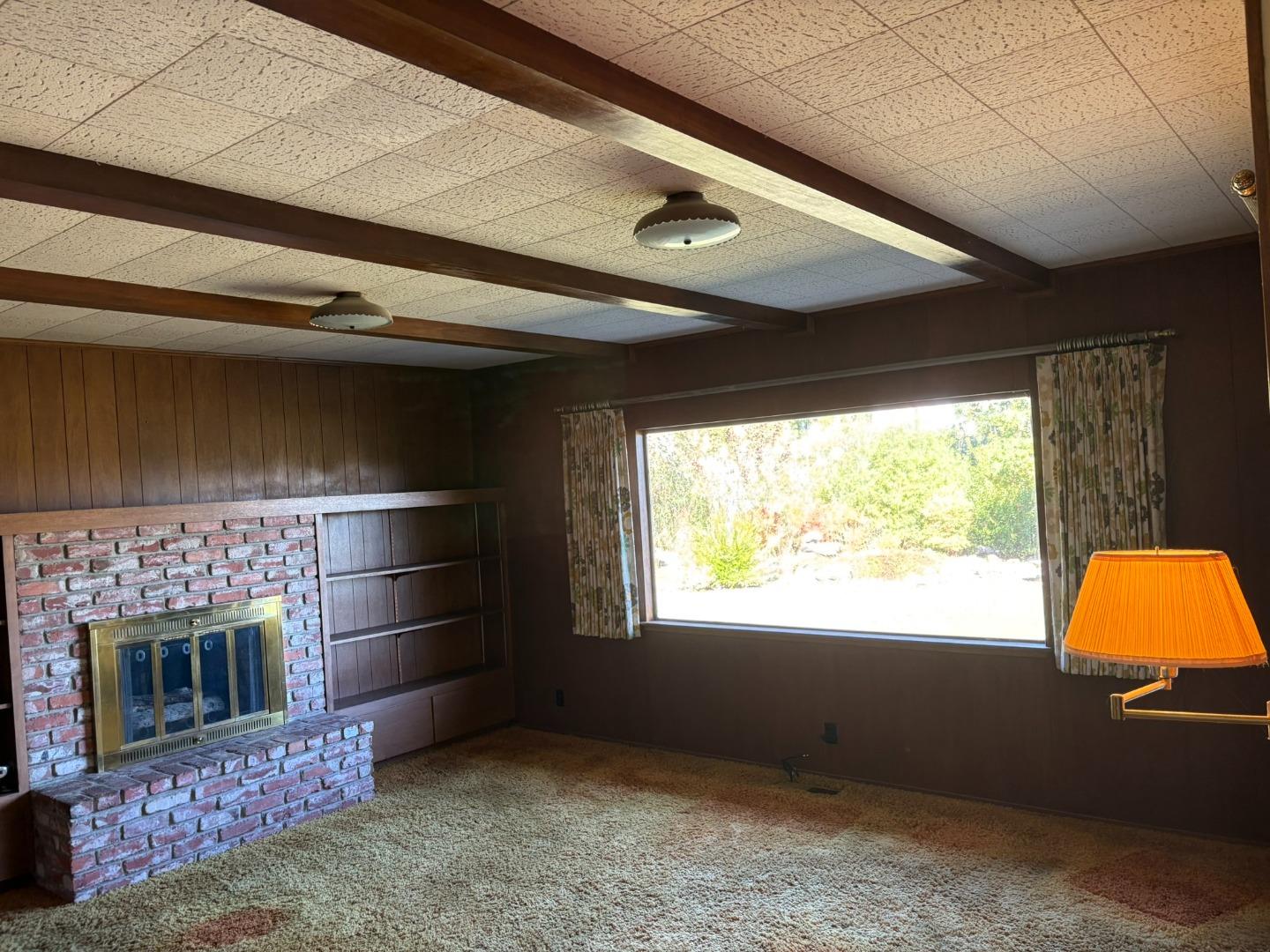 12130 Foothill Lane Los Altos Hills, CA 94022 - Photo 9 of 13 a living room with a fireplace and a fireplace