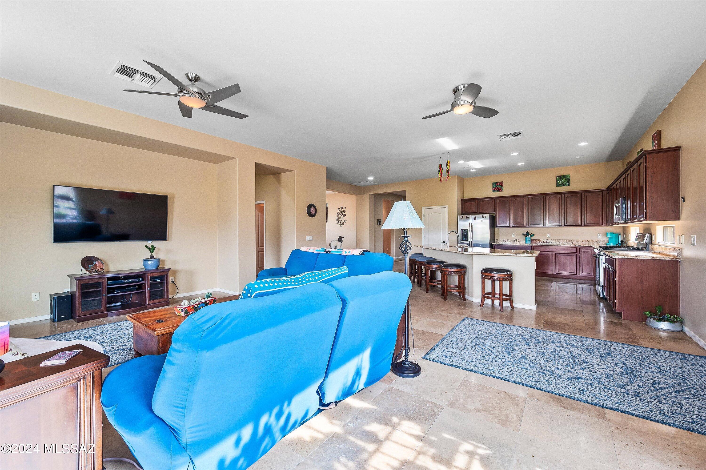8579 North Shadow Wash Way Tucson, AZ 85743 - Photo 6 of 34 a living room with furniture kitchen view and a flat screen tv