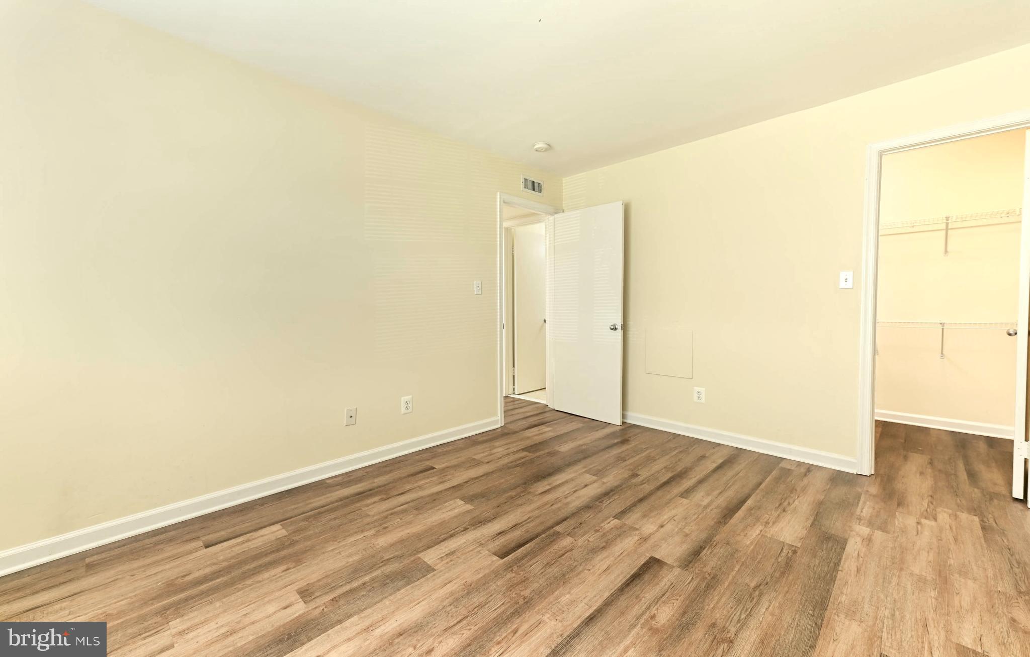 1706 Ascot Way, Unit B Reston, VA 20190 - Photo 12 of 14 an empty room with wooden floor