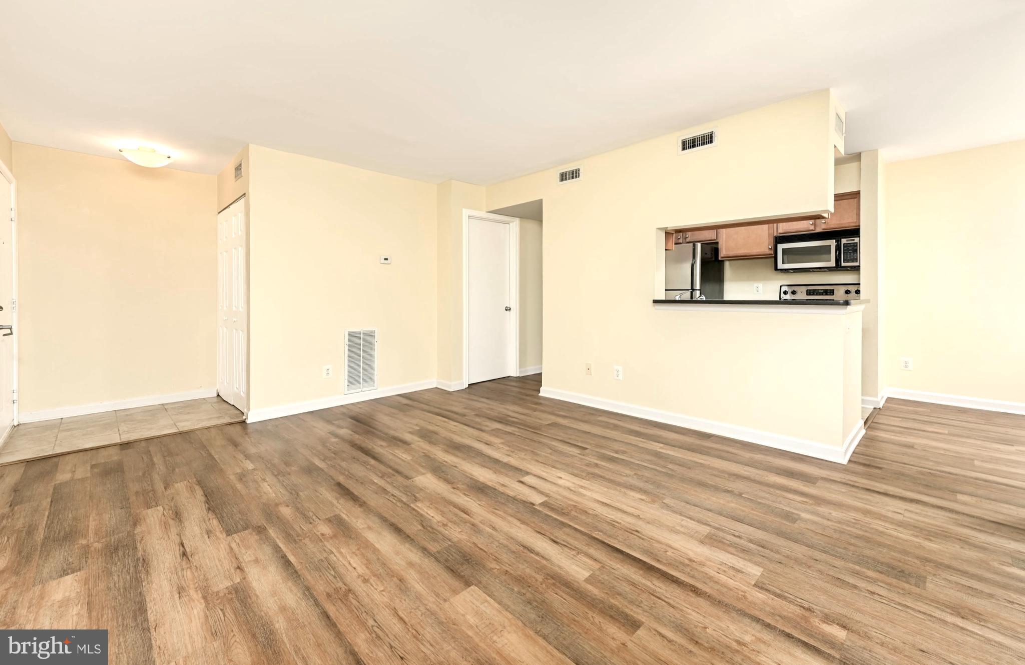 1706 Ascot Way, Unit B Reston, VA 20190 - Photo 4 of 14 a view of a bedroom with wooden floor