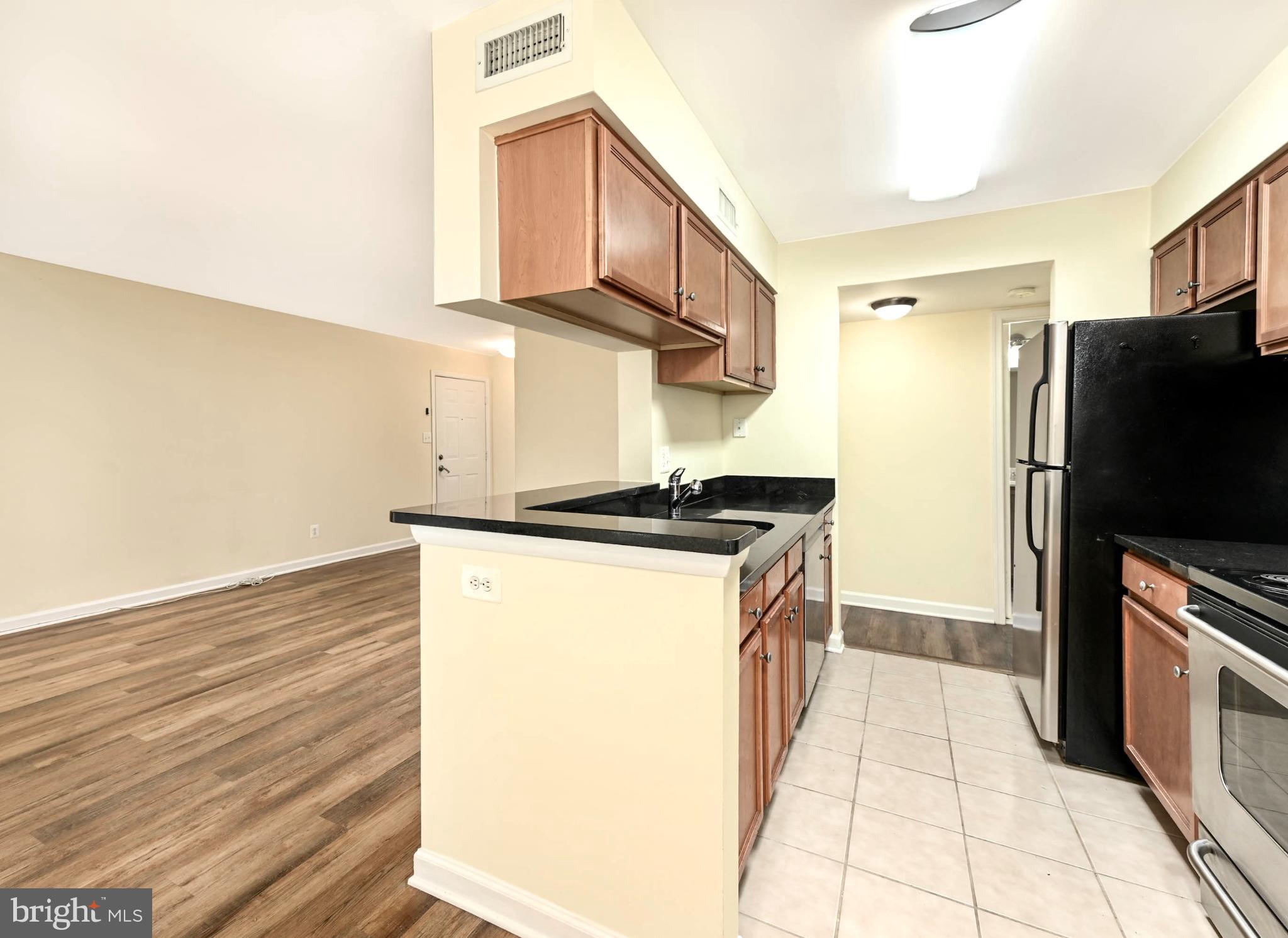 1706 Ascot Way, Unit B Reston, VA 20190 - Photo 6 of 14 a kitchen with stainless steel appliances a refrigerator and a stove