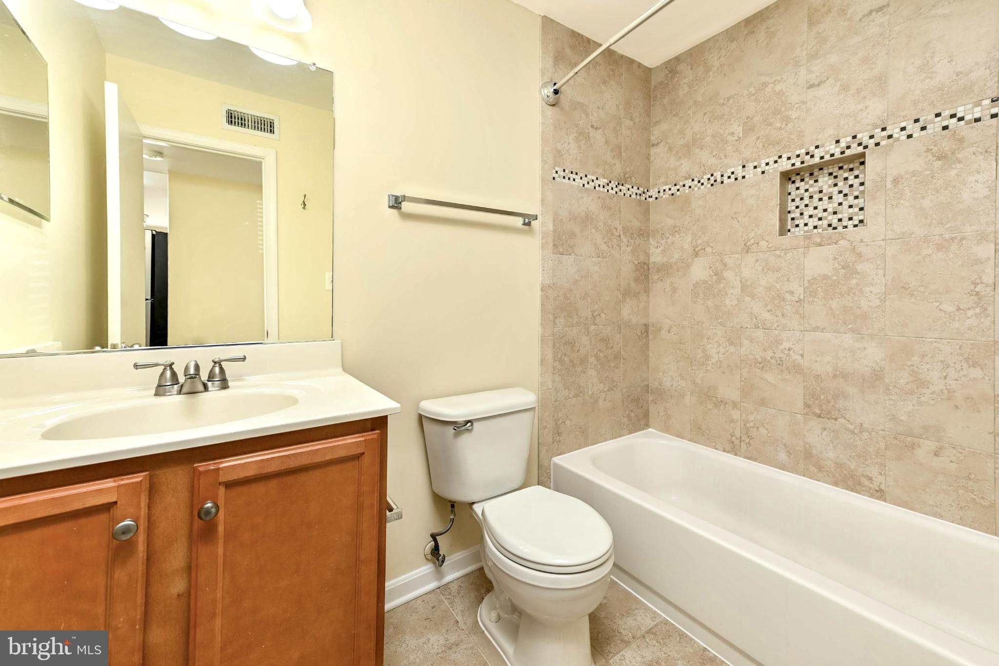 1706 Ascot Way, Unit B Reston, VA 20190 - Photo 10 of 14 a bathroom with a sink a toilet and shower