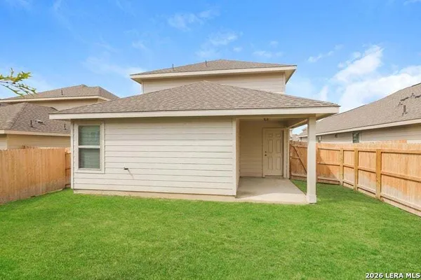 a view of a house with a backyard
