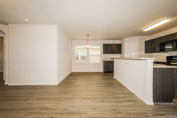a view of a kitchen with microwave and cabinets