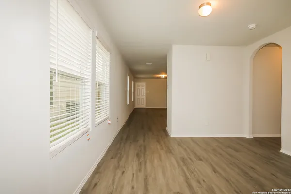 a view of a room with wooden floor and a window