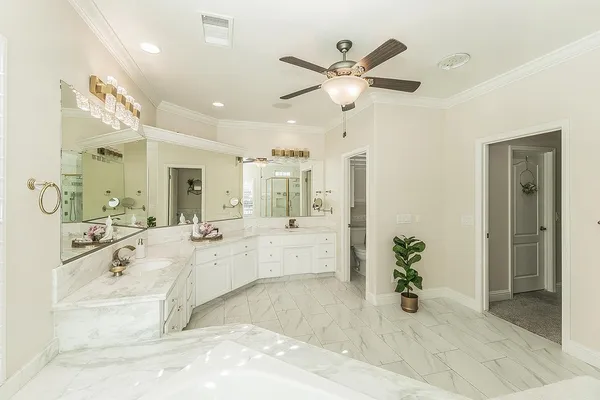 a spacious bathroom with a tub sink and mirror