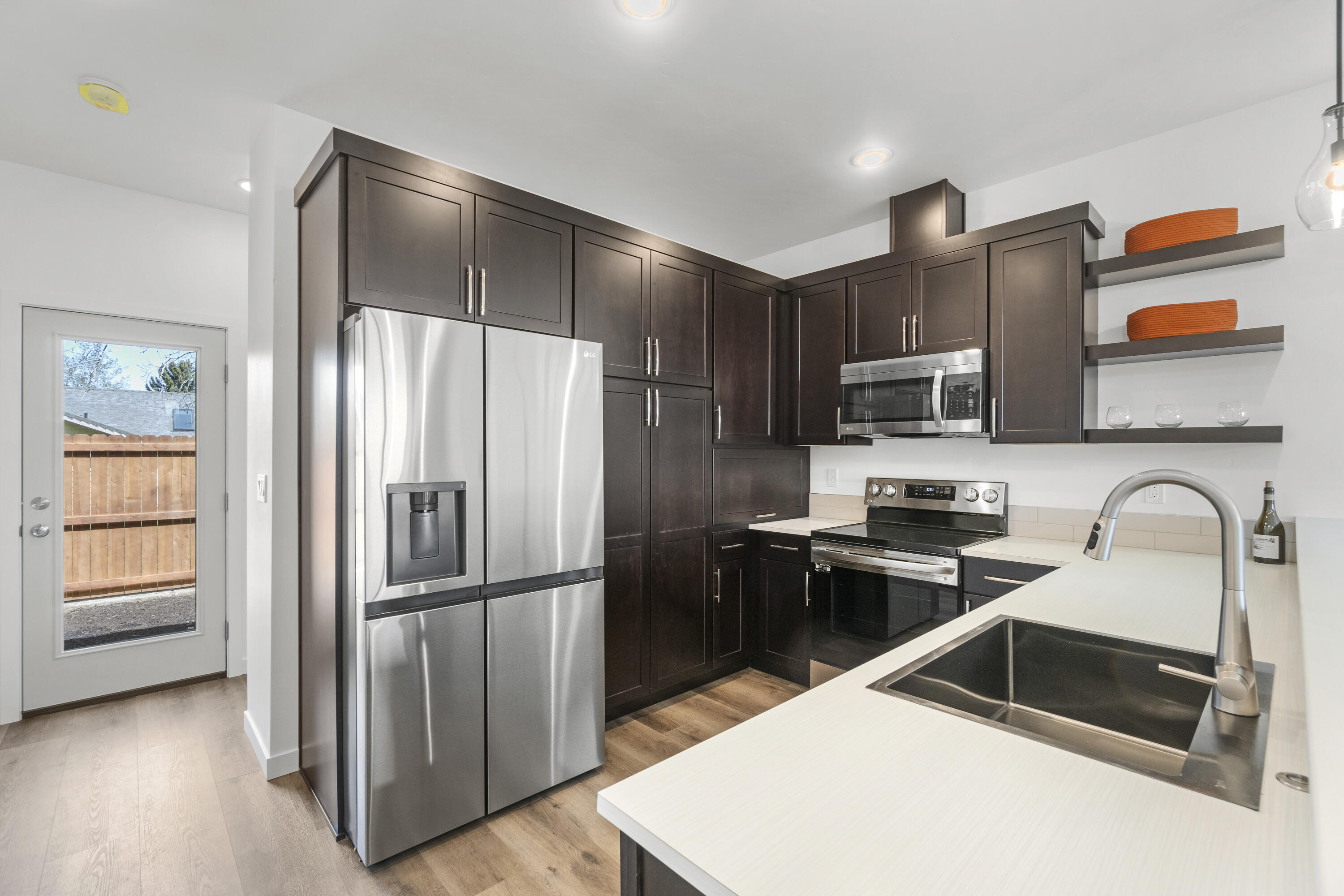 61646 Pettigrew Road, Unit 3 Bend, OR 97702 - Photo 7 of 13 a kitchen with stainless steel appliances granite countertop a refrigerator and a stove top oven
