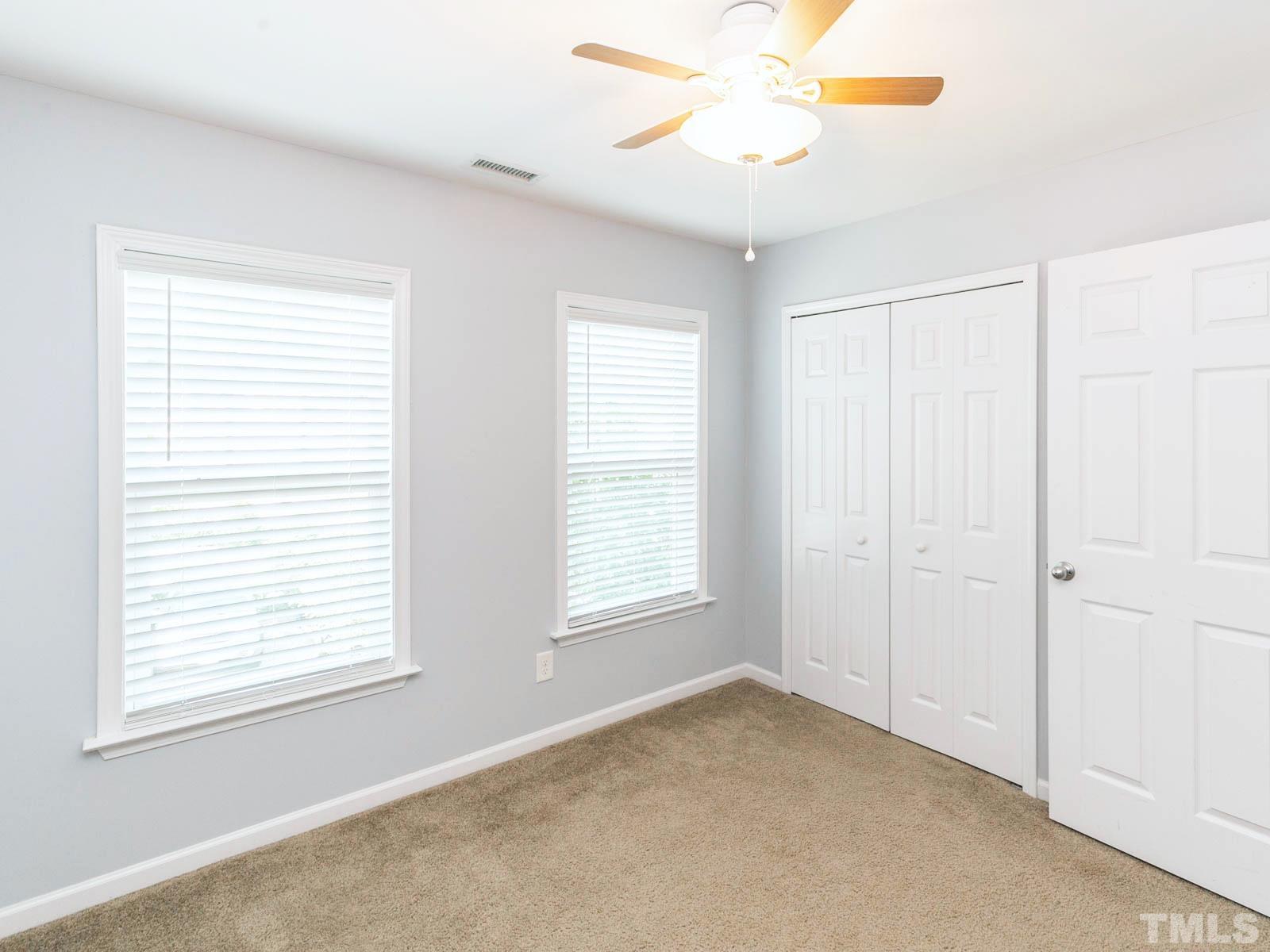 131 Deacon Ridge Street Wake Forest, NC 27587 - Photo 5 of 12 a view of an empty room with a window