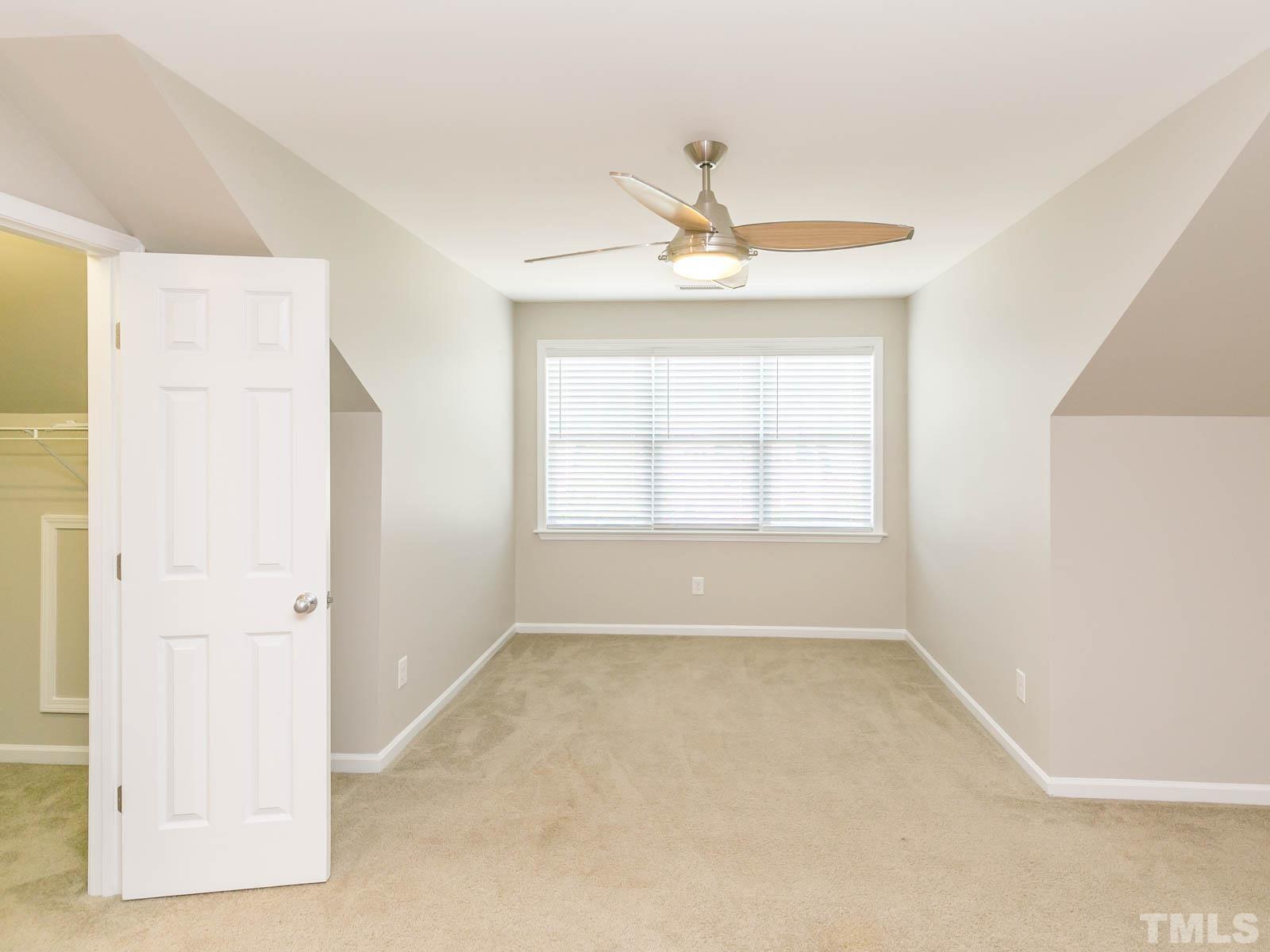 131 Deacon Ridge Street Wake Forest, NC 27587 - Photo 6 of 12 a view of an empty room with a window