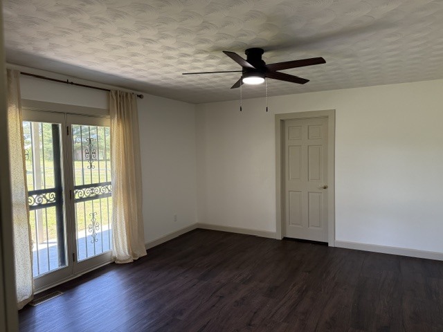 6241 Wards Mill Road Marion, IL 62959 - Photo 9 of 29 an empty room with wooden floor fan and windows