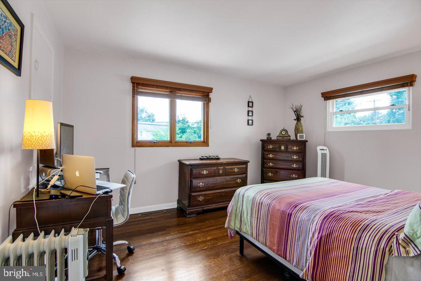 417 Dickinson Road Glassboro, NJ 08028 - Photo 14 of 36 a bedroom with a bed and wooden floor