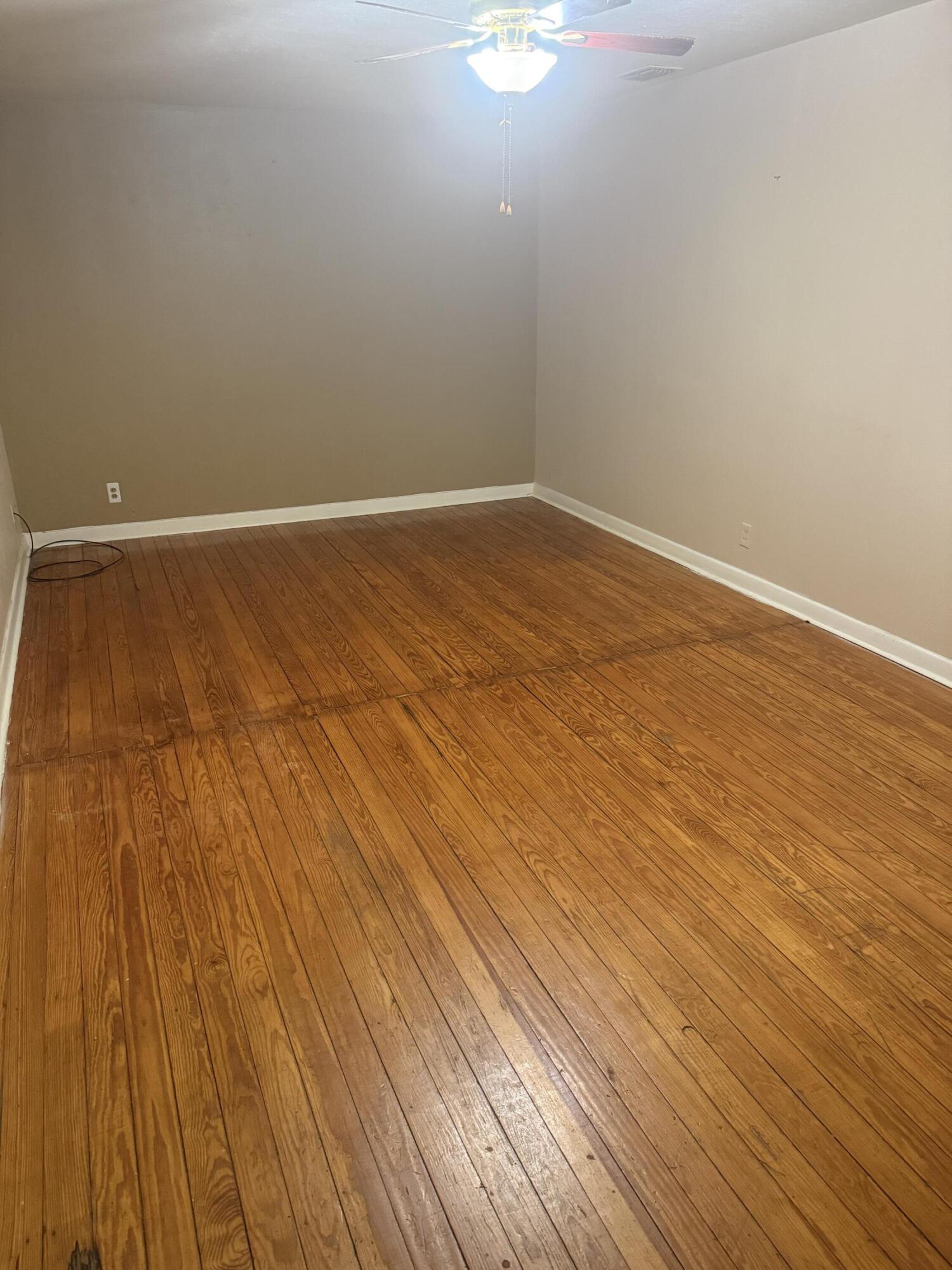 1211 Main Ralls, TX 79357 - Photo 2 of 9 a view of empty room with wooden floor