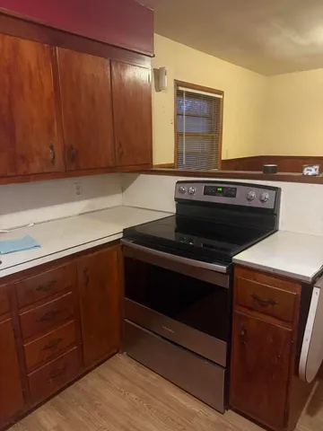 a stove top oven sitting inside of a kitchen