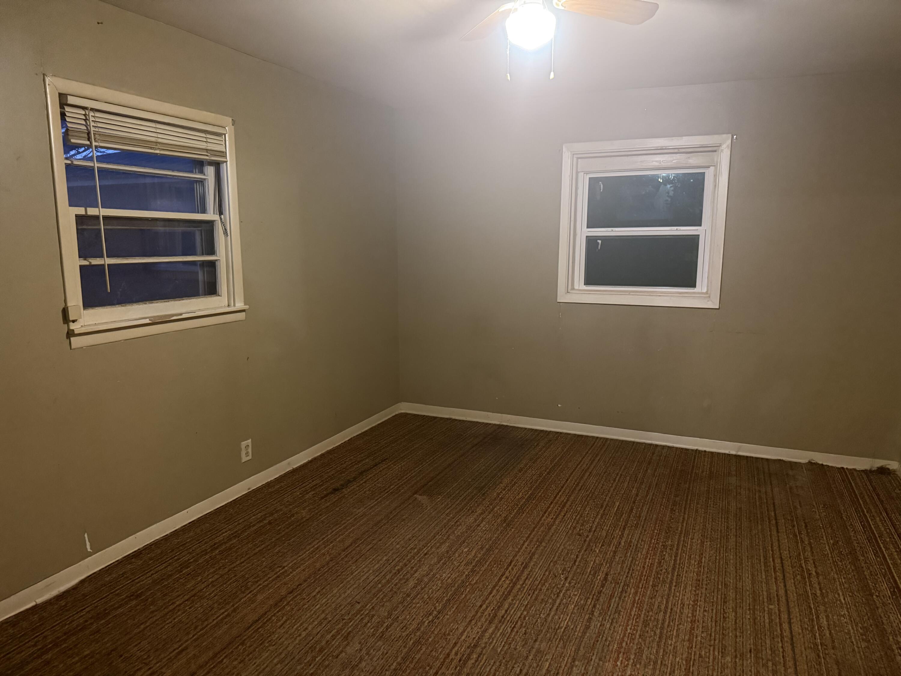 1211 Main Ralls, TX 79357 - Photo 5 of 9 a view of an empty room with wooden floor and a window