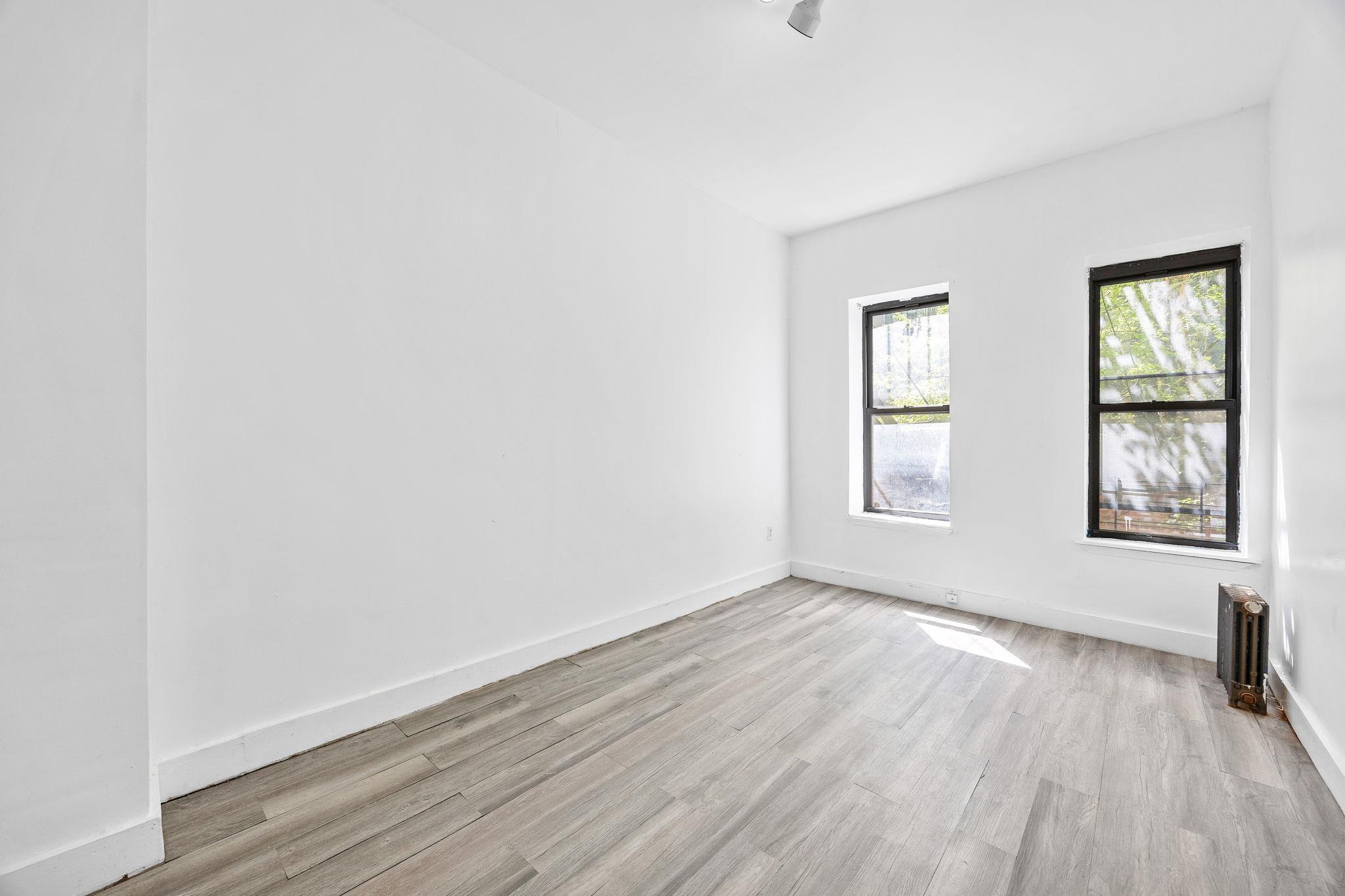 72 Richardson Street, Unit 4 Brooklyn, NY 11211 - Photo 2 of 17 Spare room featuring light wood-style flooring, baseboards, and radiator heating unit