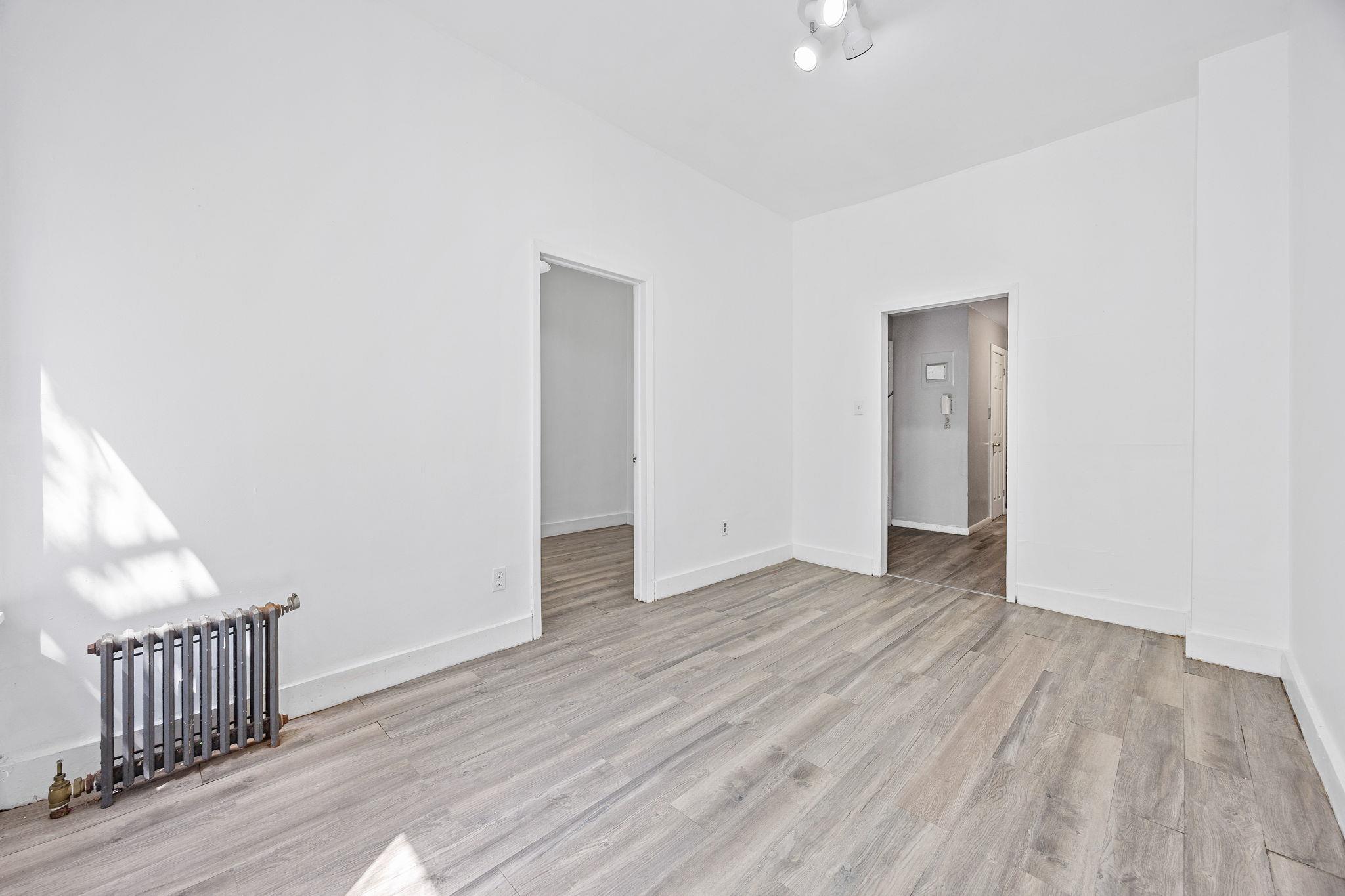 72 Richardson Street, Unit 4 Brooklyn, NY 11211 - Photo 3 of 17 Unfurnished room with baseboards, radiator heating unit, and wood finished floors
