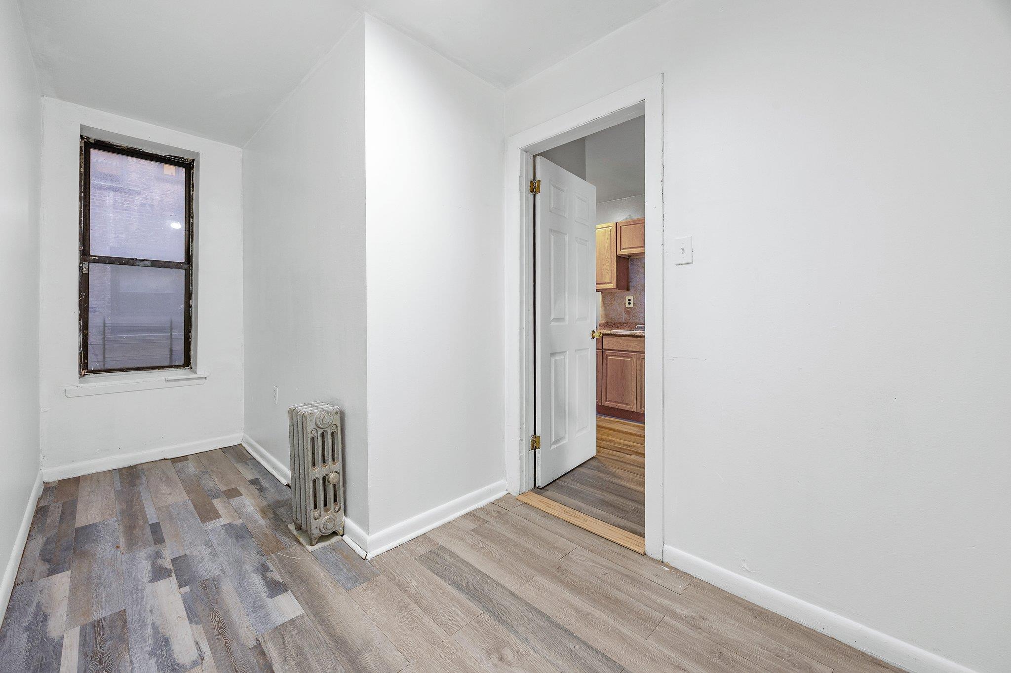 72 Richardson Street, Unit 4 Brooklyn, NY 11211 - Photo 8 of 17 Spare room with light wood-type flooring, baseboards, and radiator heating unit