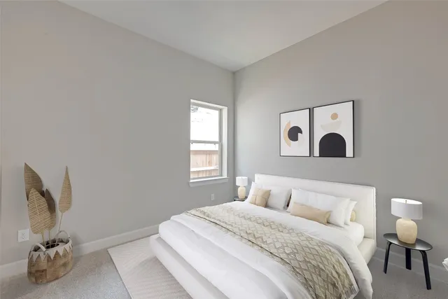 a bedroom with a bed and a painting on the wall