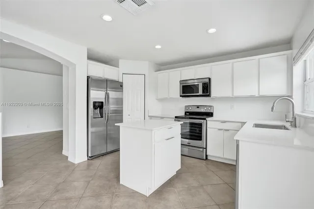 an aerial view of residential houses with outdoor space and river