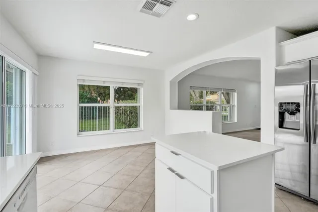 an aerial view of residential houses with outdoor space and trees