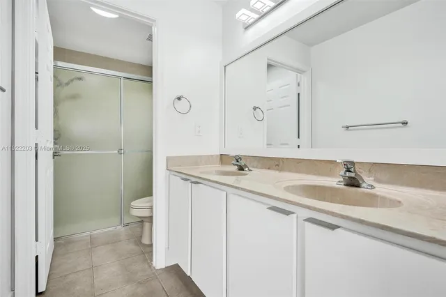 an aerial view of a house with a yard and lake view