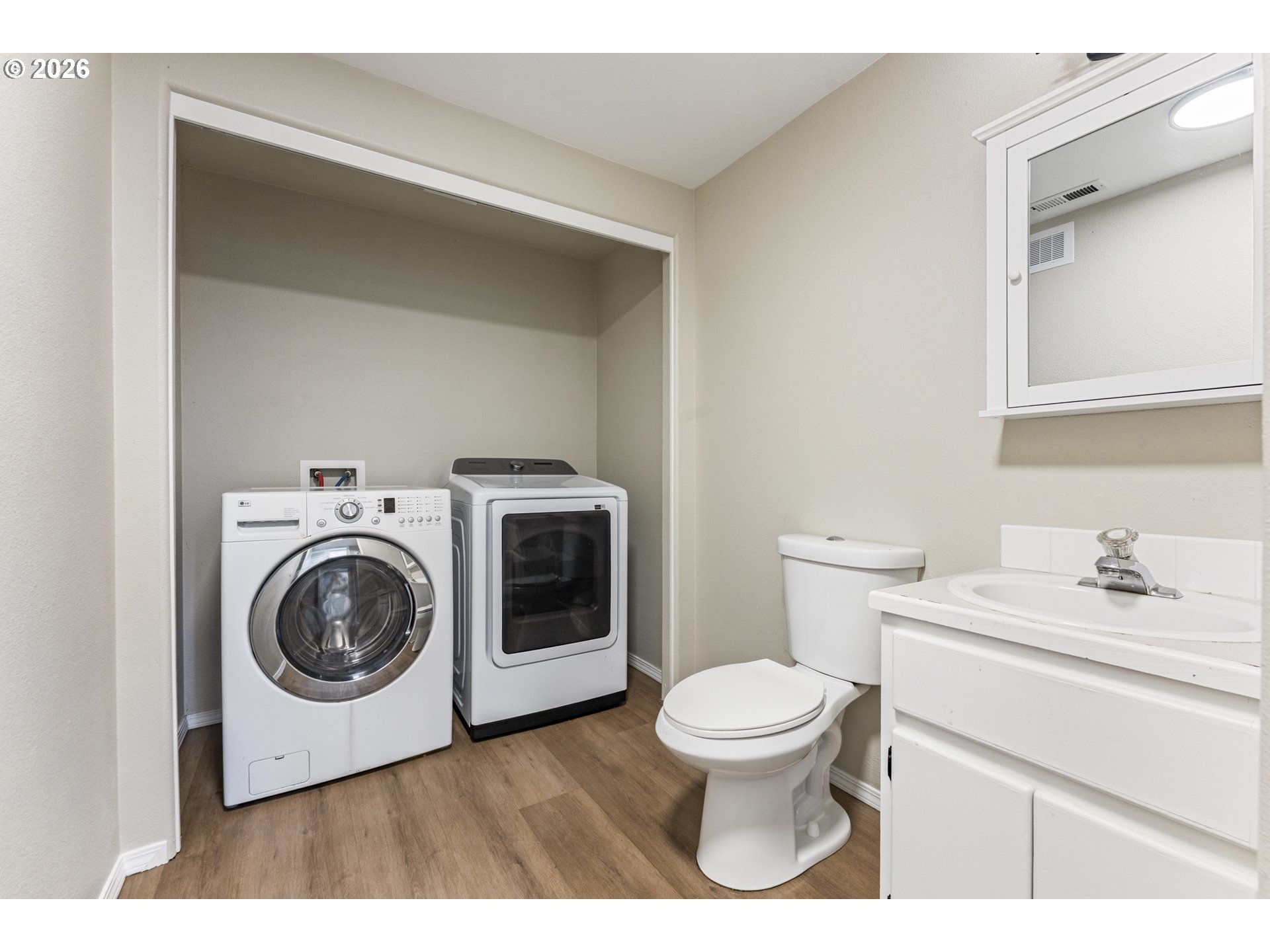 4024 Southeast 154th Place Portland, OR 97236 - Photo 27 of 43 a white toilet sitting next to a bathroom sink