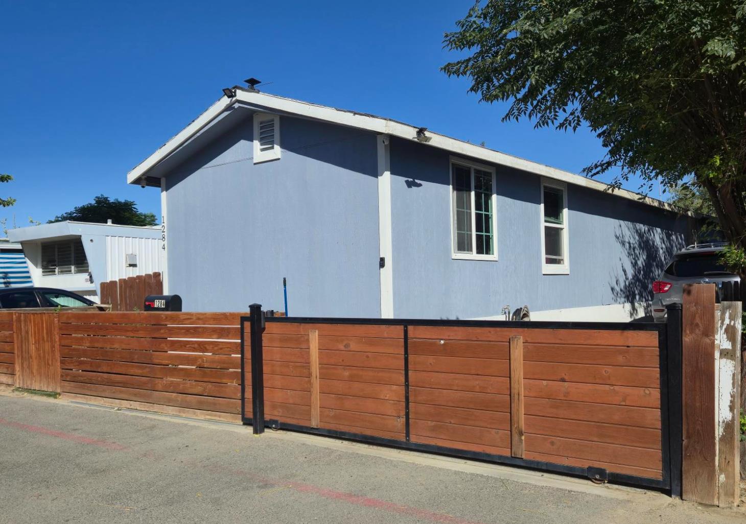 1284 Elizabeth Street, Unit 80 Coalinga, CA 93210 - Photo 1 of 24 a front view of a house with parking space