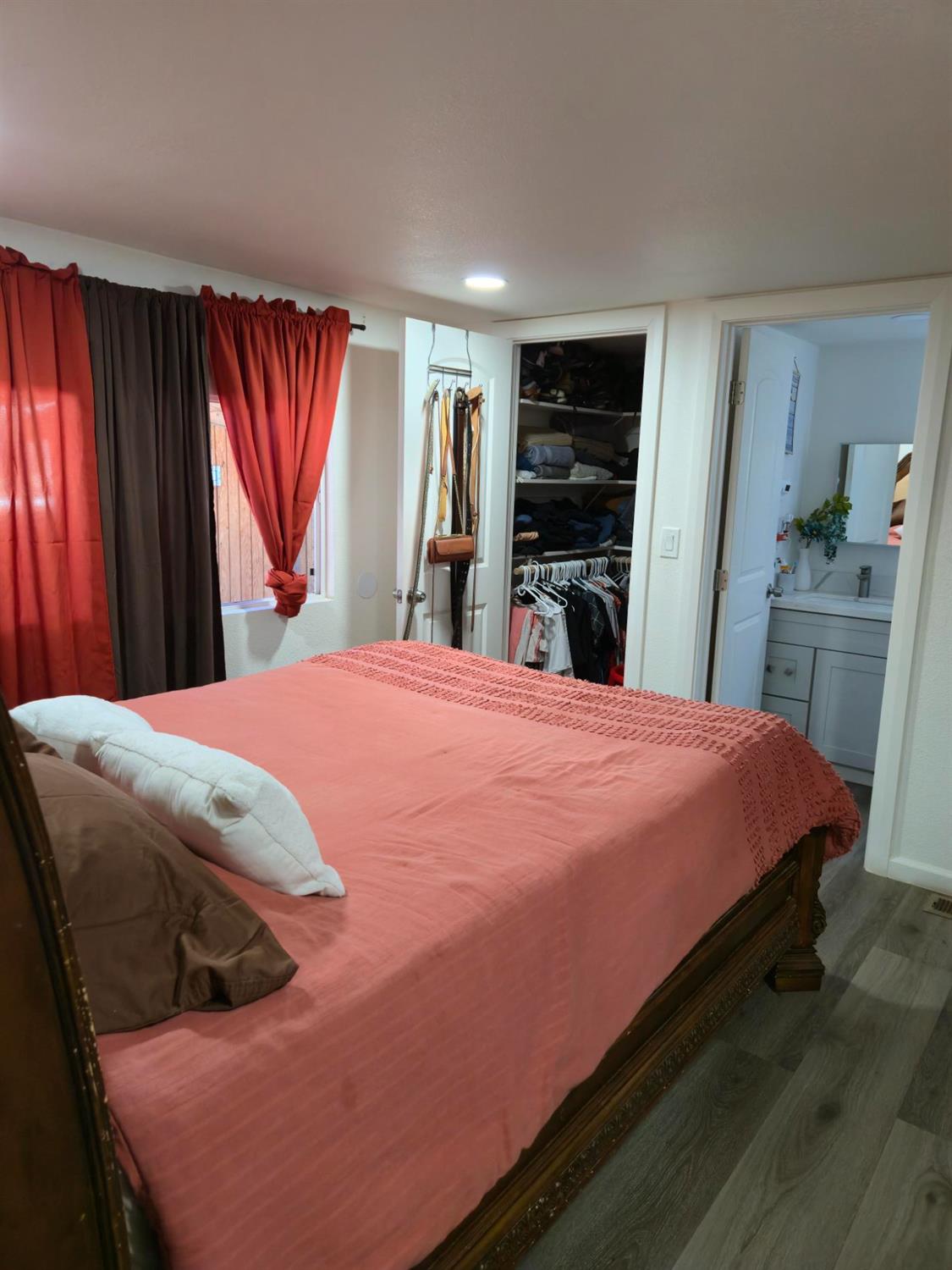 1284 Elizabeth Street, Unit 80 Coalinga, CA 93210 - Photo 11 of 24 a bed sitting in a bedroom and kitchen chandelier